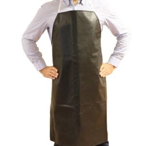 Man wearing a dark brown apron over a light button-down shirt, standing with hands on hips and a slight smile.