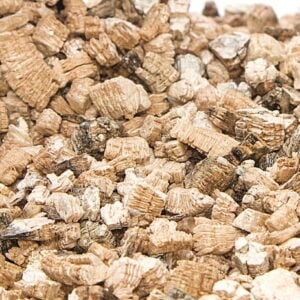 Close-up of brown wood chips or bark mulch spread in a garden bed